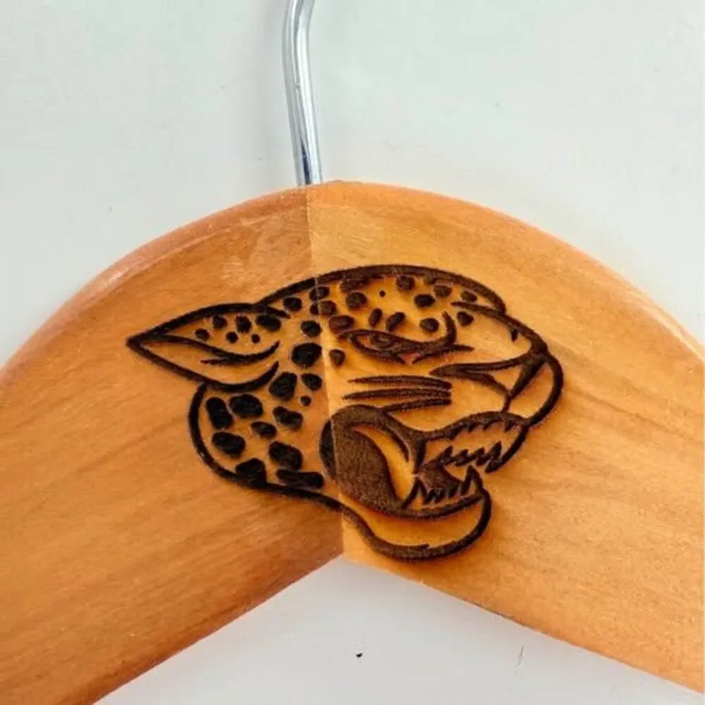 5 custom wood hangers with Jacksonville Jaguars branding.